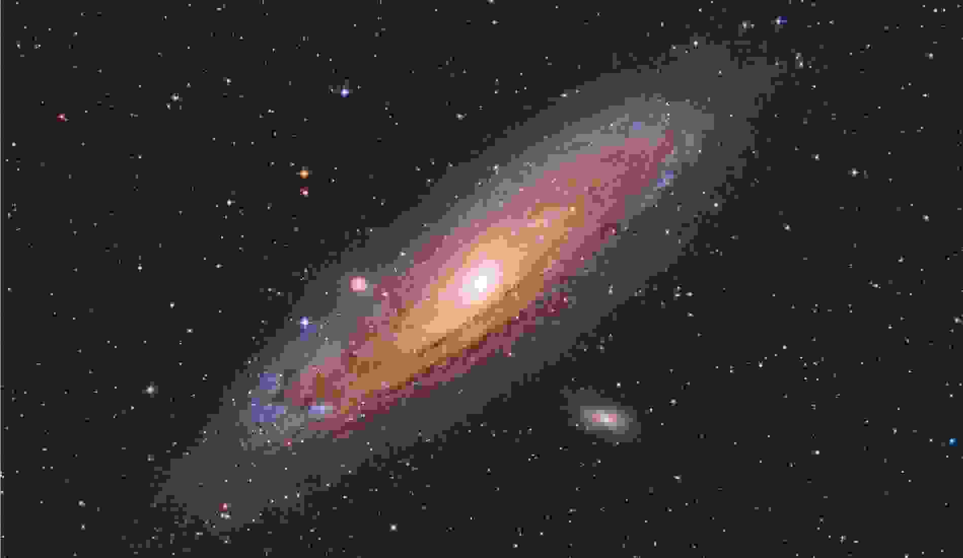 Andromeda Galaxy with colourful Stars surrounding it captured with a Telescope