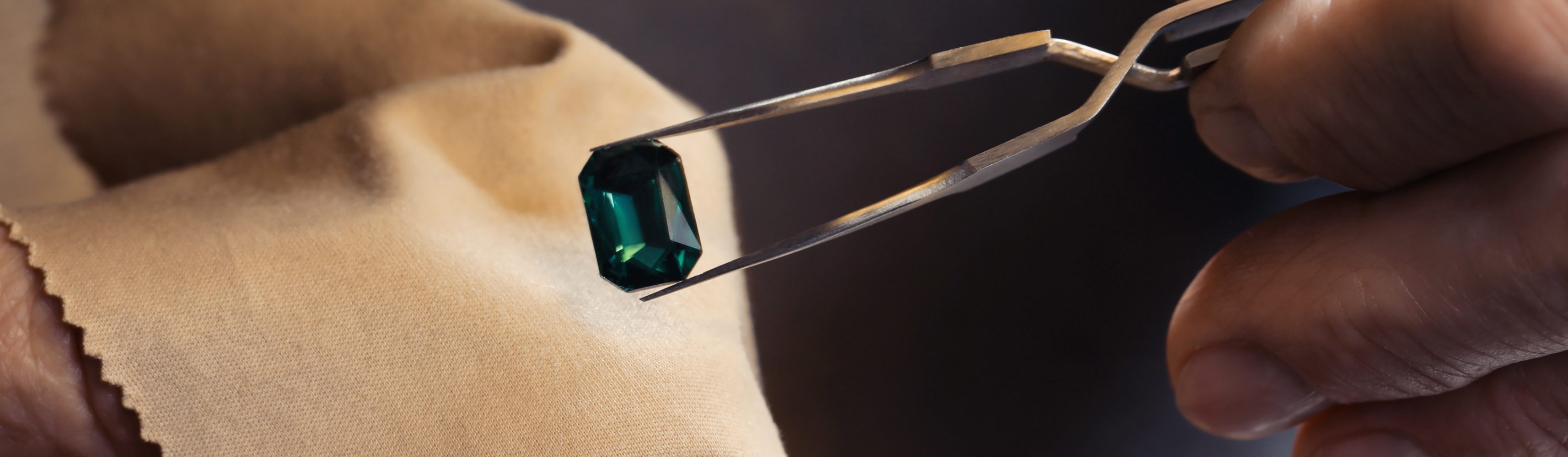 Professional jeweler working with gemstone, closeup view