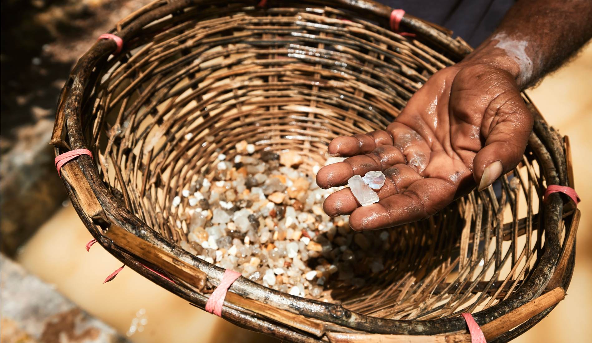 Worker showing gemostones found in Moonstone mine in Sri Lanka. This gemstones is later processed for making jewellery