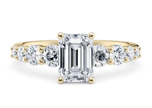 Lyra in Yellow Gold set with a Emerald cut diamond.